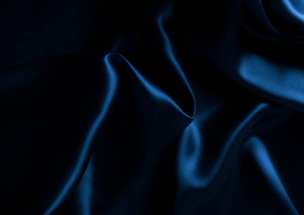 istock Satin blue silk background, close-up 1213516384