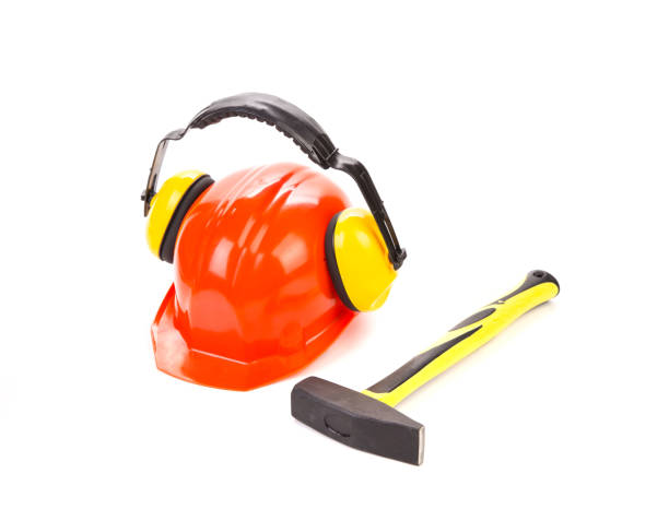 istock Still life with a hammer and a protective helmet with headphones. 1213518037