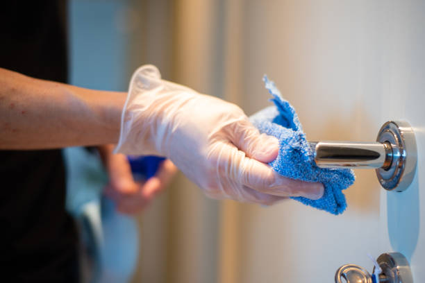 istock Disinfecting a door knob 1213518461