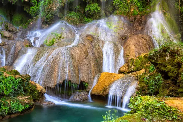 A part of El Nicho Waterfalls in Cuba. El Nicho is located inside the Gran Parque Natural Topes de Collantes a forested park that extends across the Sierra Escambray mountain range in central Cuba.