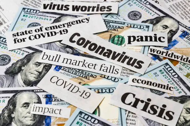 Photo of Coronavirus, covid-19 news headlines on United States of America 100 dollar bills. Concept of financial impact, stock market decline and crash due to worldwide pandemic