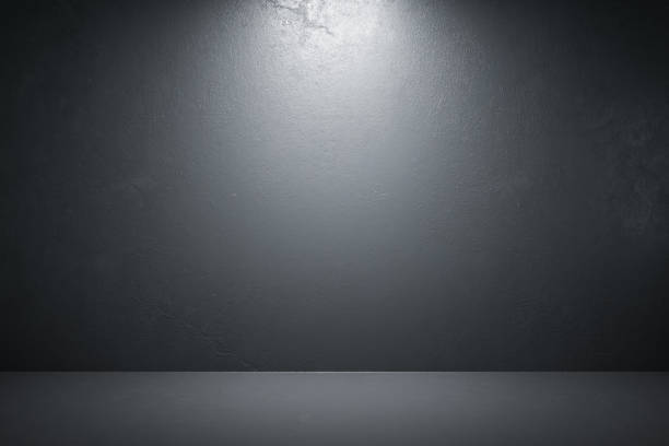 istock Front view of interior room with blank black concrete wall 1213521993