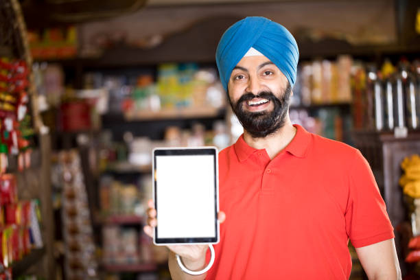 istock Man pointing at blank digital tablet screen in supermarket 1213525196