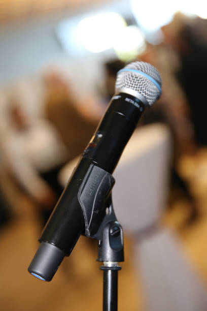 istock Close up old microphone in conference room on table at seminar teaching room front speaking conference hall 1213525240