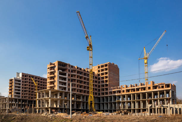 istock Work in progress on a new apartment block. Tall building under construction with cranes. Construction Site of New Building 1213525765