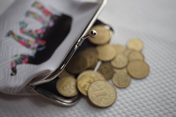 istock Open purse with golden coins inside and on the table 1213526065
