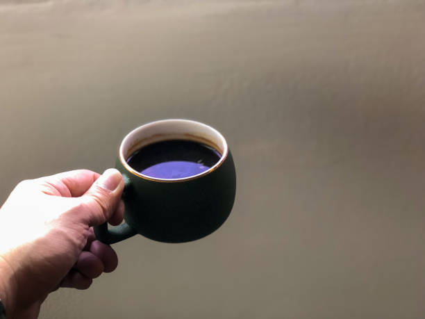 istock Hand holding a cup of black coffee 1213526711