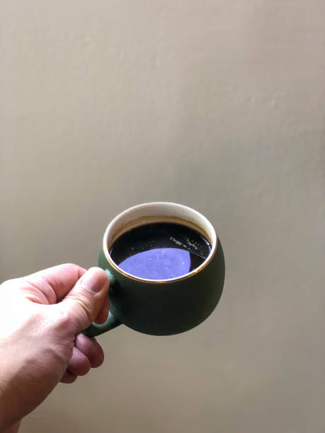 istock Hand holding a cup of black coffee 1213526715