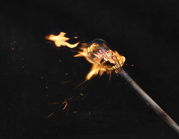istock wooden burning torch on a black background 1213527612