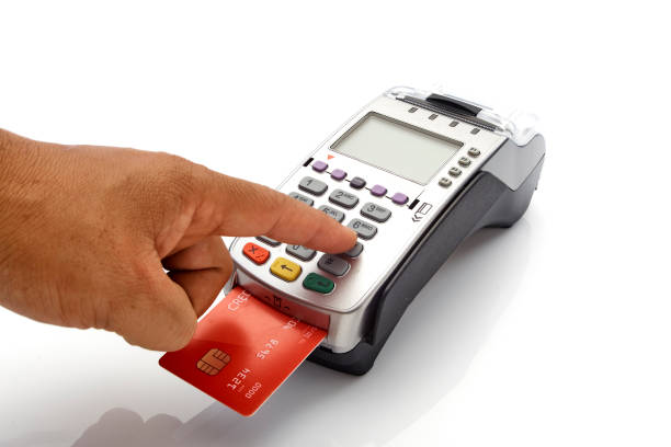 istock Hand swipe red credit through payment terminal on white background 1213529337