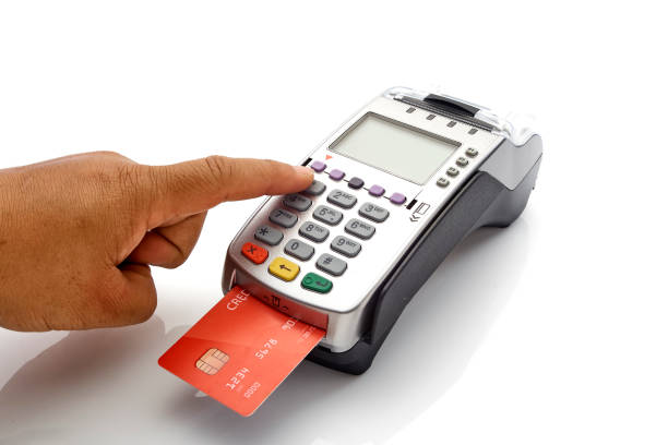 istock Hand swipe red credit through payment terminal on white background 1213529338