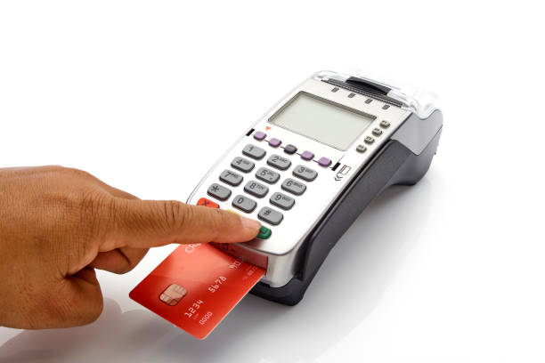 istock Hand swipe red credit through payment terminal on white background 1213529373