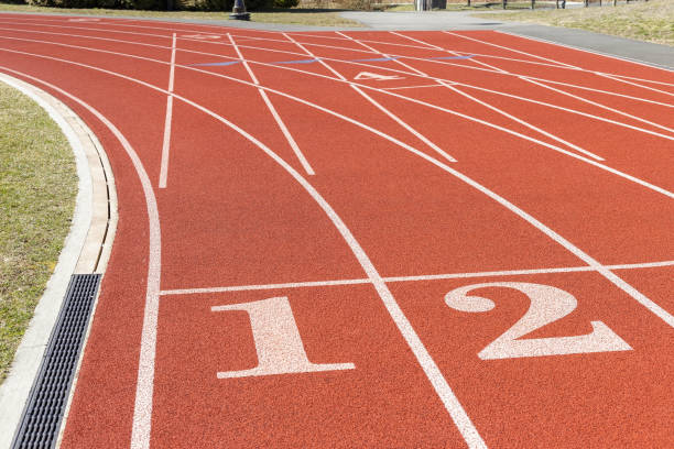 istock Red color running track in school stadium 1213530748