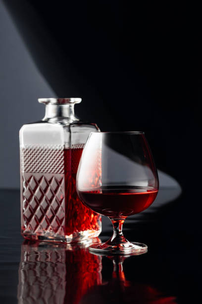 istock Decanter and glass of brandy on a black background. 1213531361