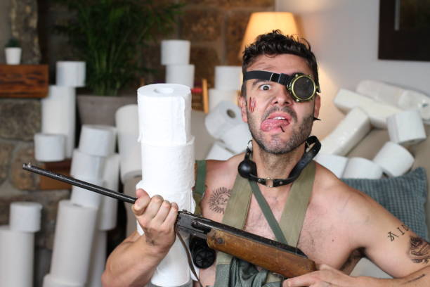 istock Apocalyptical looking man stocking up toilet paper at home 1213533480