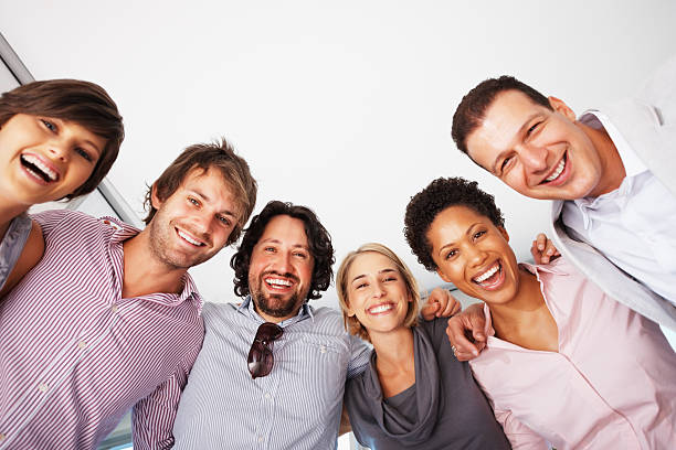 istock Smiling business people in a huddle 121353351