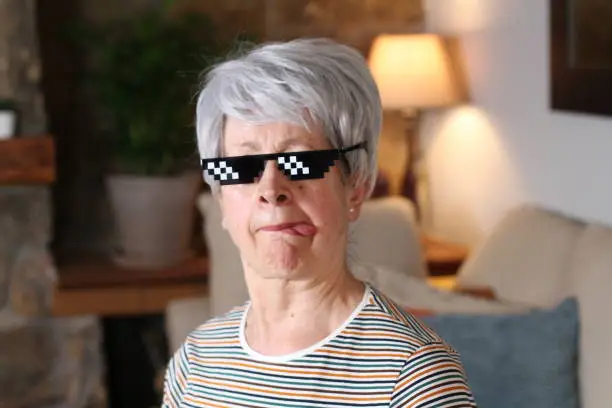Senior woman wearing pixelated sunglasses.
