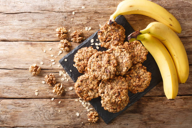 banana cookies with ingredients close-up on a slate board. Horizontal top view banana cookies with ingredients close-up on a slate board on the table. Horizontal top view from above walnut cookies stock pictures, royalty-free photos & images