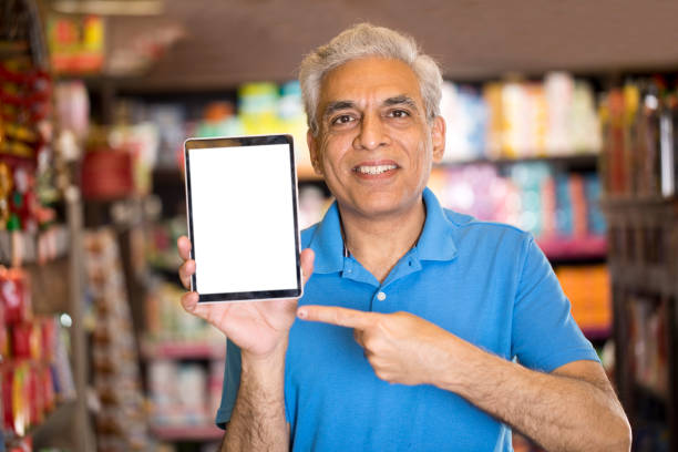 istock Man pointing at blank digital tablet screen in supermarket 1213534972