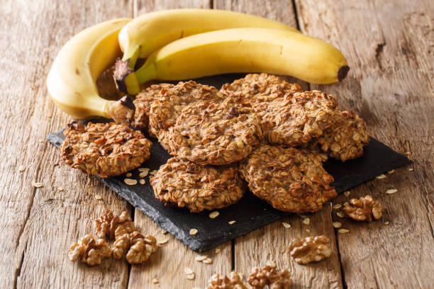 banana cookies with ingredients close-up on a slate board. horizontal banana cookies with ingredients close-up on a slate board on the table. horizontal oatmeal cookie stock pictures, royalty-free photos & images