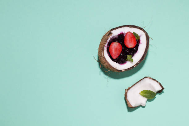 istock berries in half coconut on a goalkby background. copy space 1213535043