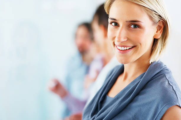 istock Attractive woman with colleagues in background 121353819