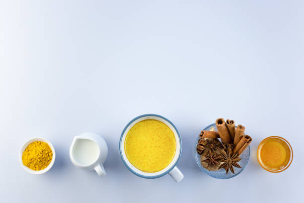 istock Golden milk, turmeric, honey, ginger root, cinnamon and other ingredients on grey background. Masala Haldi Doodh 1213540632
