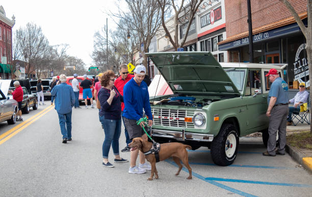 Monroe, Georgia - March 14, 2020: Visitors walk among the classic automobiles on display at the 15th Annual Memories in Monroe Car Show.