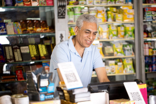 Happy man working as a cashier at supermarket