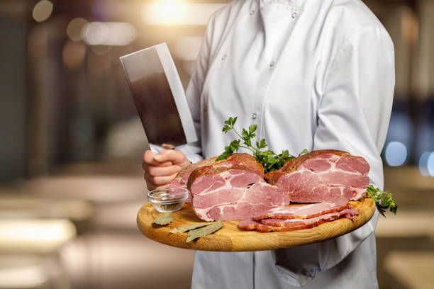 istock A cook shows sliced ham on a board . 1213541540