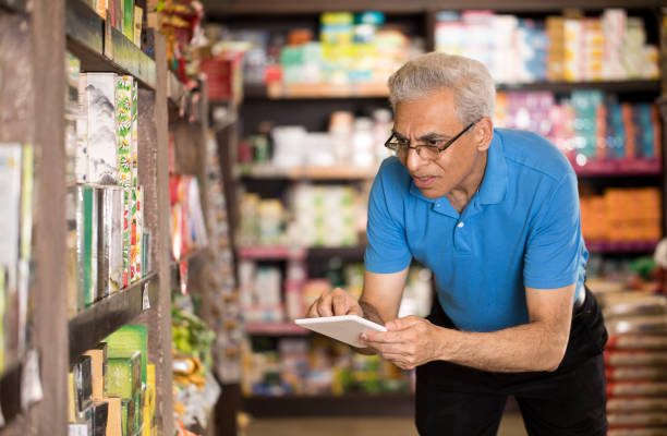 istock Happy man with digital tablet at grocery store 1213541572