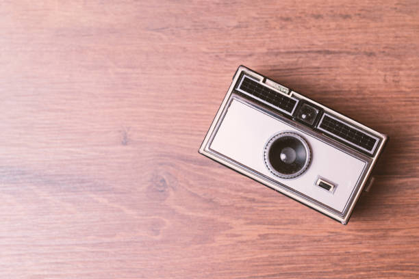 Retro classic 35mm photo camera on wooden Background