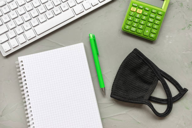 istock Home office background. Mask and notebook on gray 1213542980