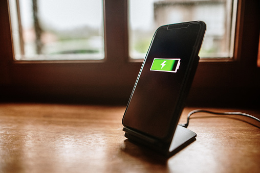 A smartphone being charged using a wireless charger