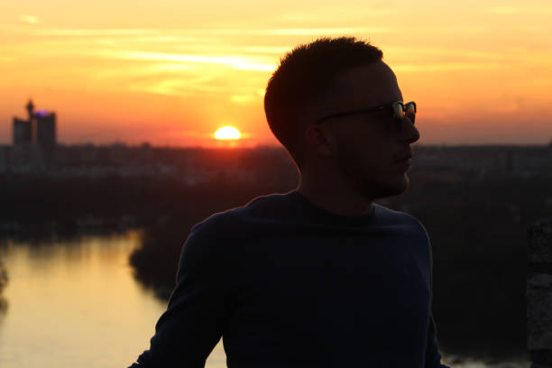 istock Young man enjoying in sunset 1213547623