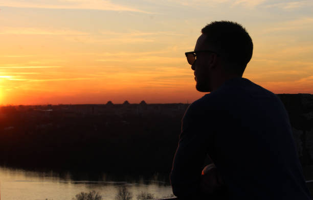 istock Young man enjoying in sunset 1213547644