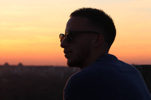 istock Young man enjoying in sunset 1213548186
