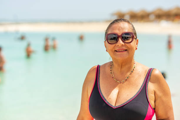 istock Senior Hispanic woman on Caribbean beach 1213548734