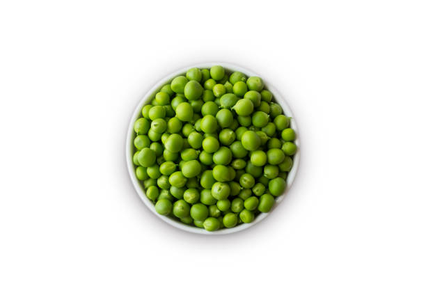 istock Green peas on bowl isolated on a white background. Vegetables with copy space for text. Green peas isolated on white. Top view. Isolated macro food photo close up from above on white background. 1213549568