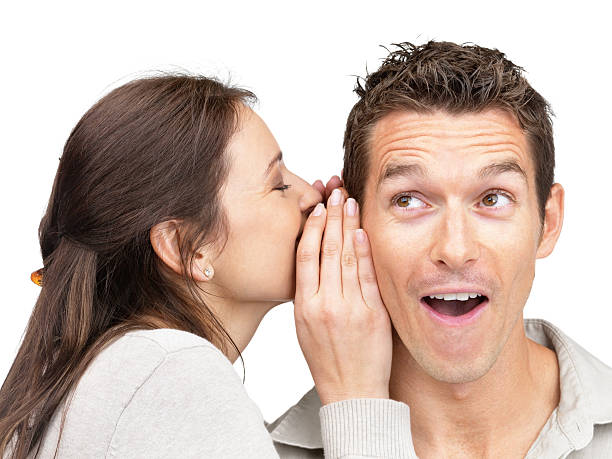 istock Young woman telling secret to a man 121355041