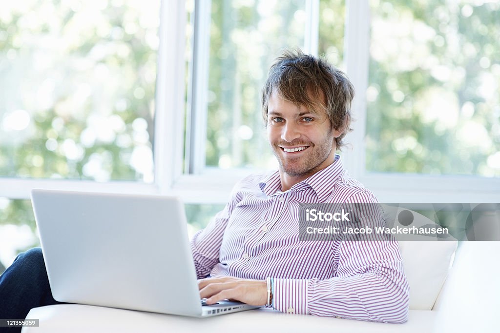 Smiling man working from home  20-29 Years Stock Photo