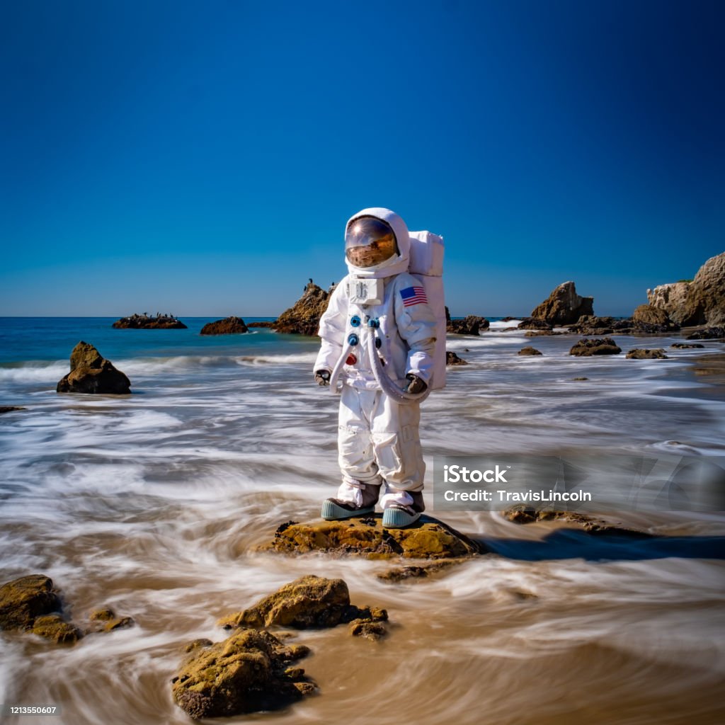 Spaceman in the Surf An astronaut stands in the shallow waves of Malibu's El Matador Beach. It's weird, unique, doesn't make any sense... and yet for some reason, it's really cool. Astronaut Stock Photo