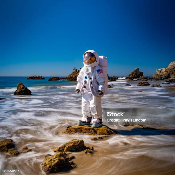 Spaceman In The Surf Stock Photo - Download Image Now - Astronaut, Beach, Futuristic