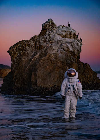 An astronaut stands in the shallow waves of Malibu's El Matador Beach. It's weird, unique, doesn't make any sense... and yet for some reason, it's really cool.
