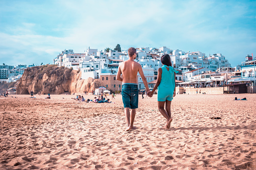 happy Young couple walking at the beach of Albufeira Algarve Portugal Algarve