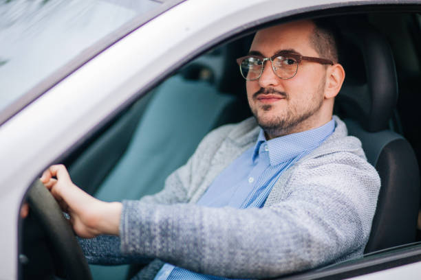 istock Businessman driving a car 1213551160