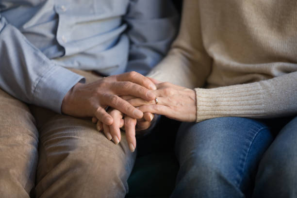 istock Close up middle aged family couple holding hands, supporting. 1213552205