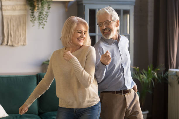 istock Active senior couple have fun dancing in living room 1213552211