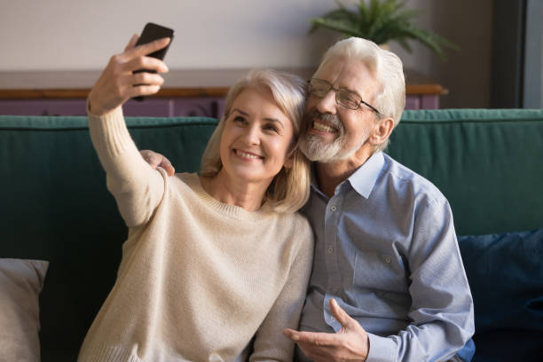 istock Modern smiling senior couple take selfie on smartphone 1213552218