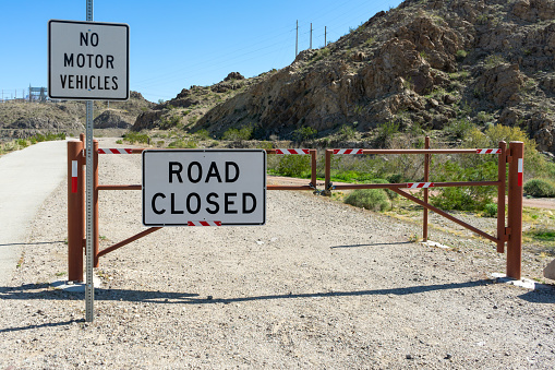 Laughlin, NV / USA – February 19, 2020: Road Closed and No Motor Vehicles signs on a dirt road in the Heritage Greenway Park and Trails located north of Laughlin, Nevada.